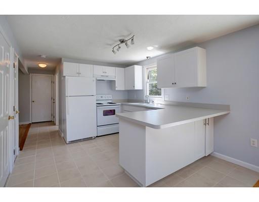 215 Simons Road Mashpee, MA 02649 - Photo 8 of 19 a kitchen with kitchen island a sink stainless steel appliances and white cabinets