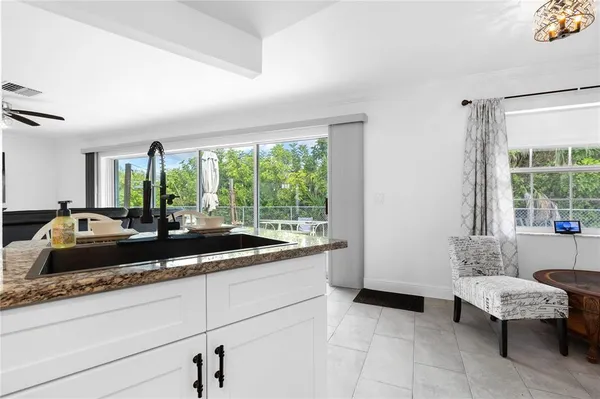 a large kitchen with kitchen island a large window in it