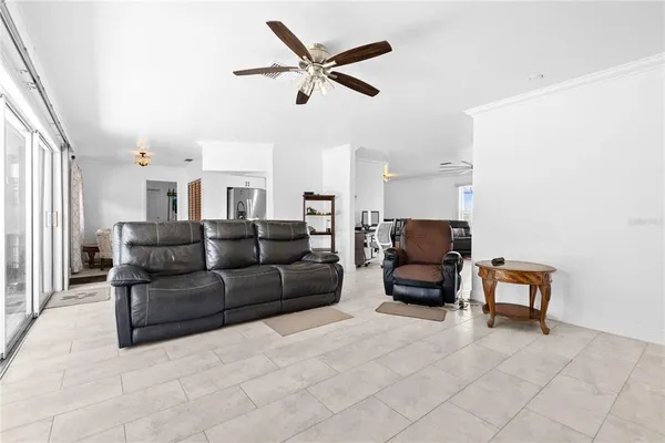 a living room with furniture and a ceiling fan