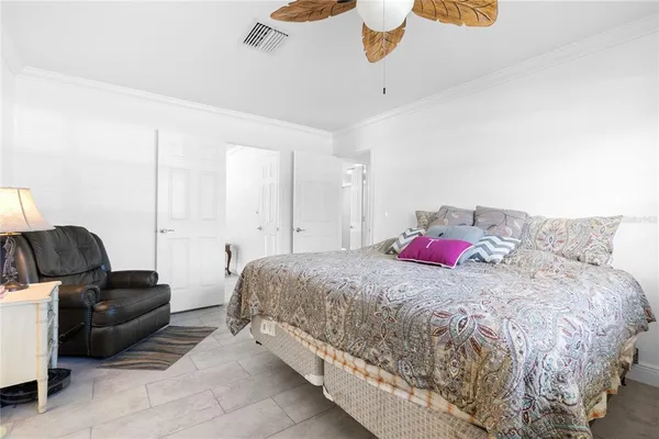 a bedroom with a bed and ceiling fan