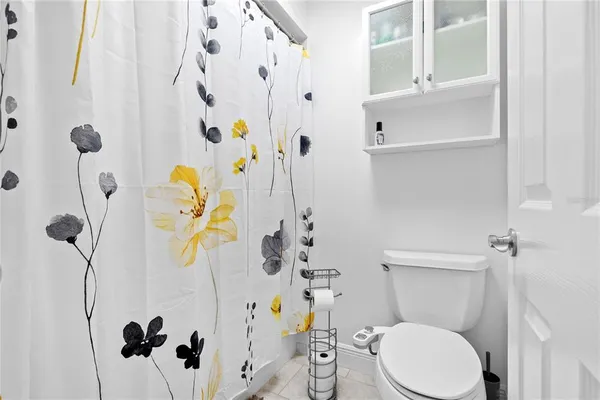 a white toilet sitting next to a bathroom sink