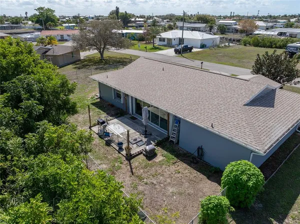 an aerial view of a house with garden space and street view