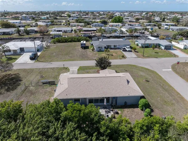 an aerial view of a house with yard garage and lake view