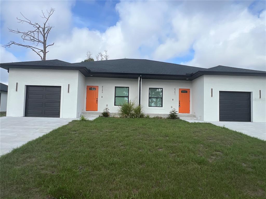 8251 Dimstead Street Port Charlotte, FL 33981 - Photo 1 of 1 a front view of house with yard and garage