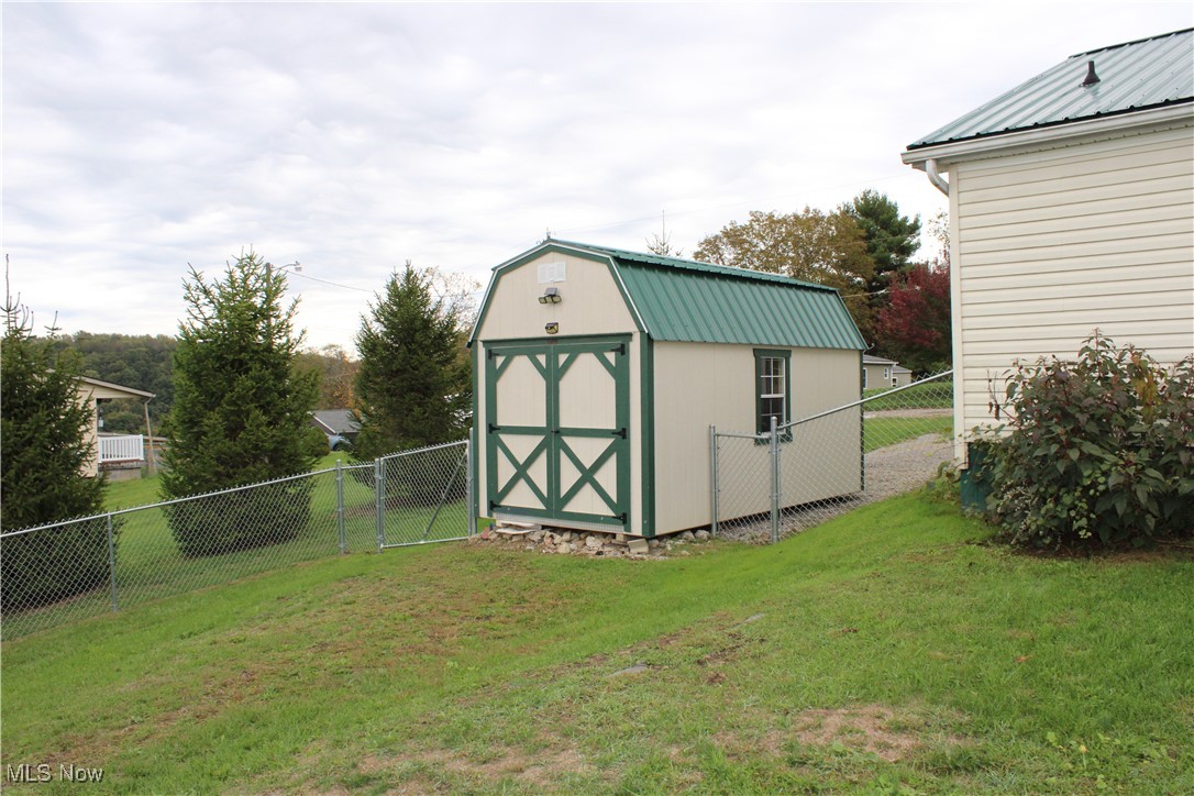 56 3rd Street Rayland, OH 43943 - Photo 13 of 46 View of shed with a fenced backyard and a gate