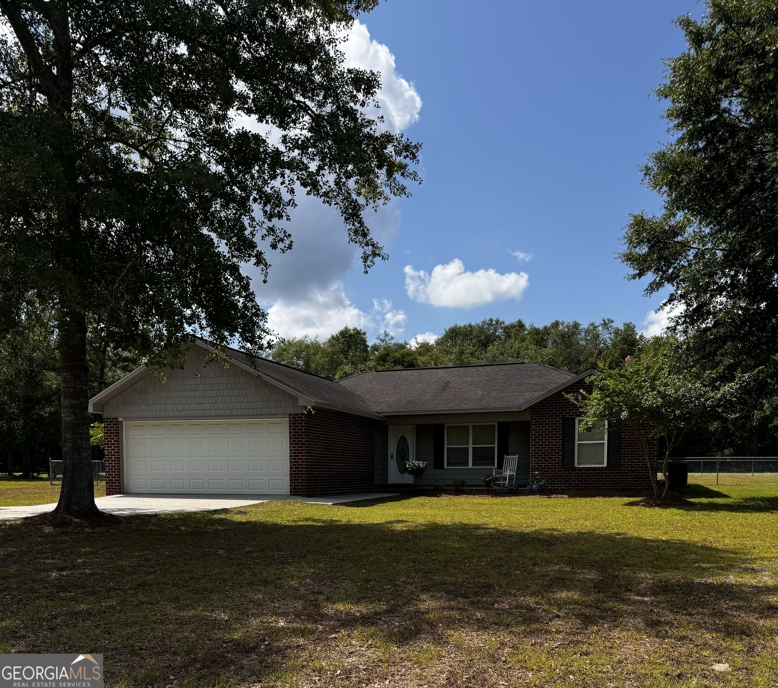 173 Rabun Avenue Reidsville, GA 30453 - Photo 1 of 1 a front view of house with yard and trees in the background