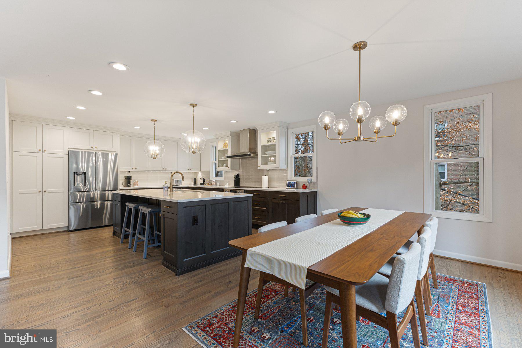 1875 Massachusetts Avenue McLean, VA 22101 - Photo 15 of 52 a view of a dining room and livingroom with furniture wooden floor a rug a chandelier