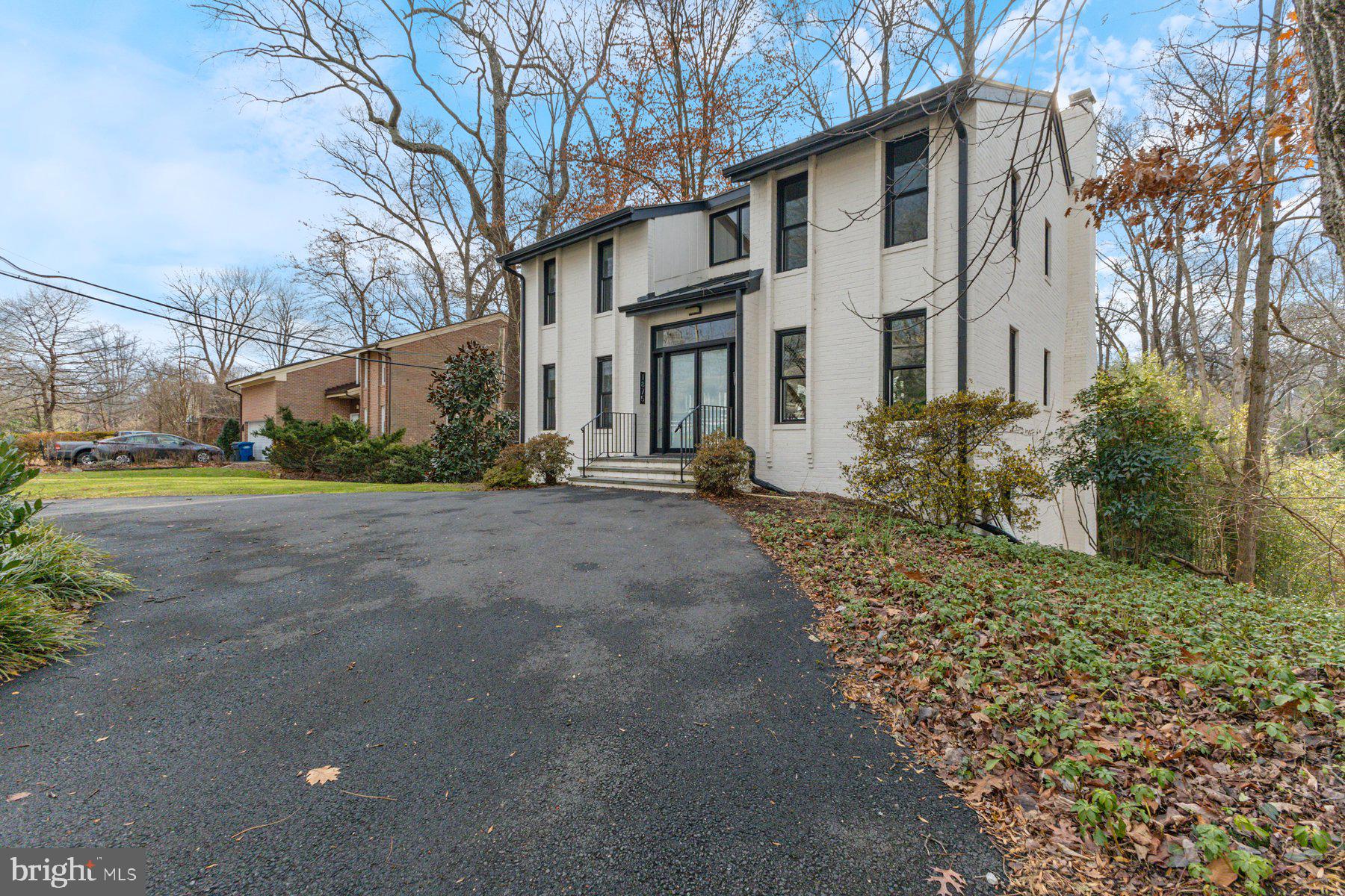 1875 Massachusetts Avenue McLean, VA 22101 - Photo 2 of 52 a front view of a house with a yard and garage