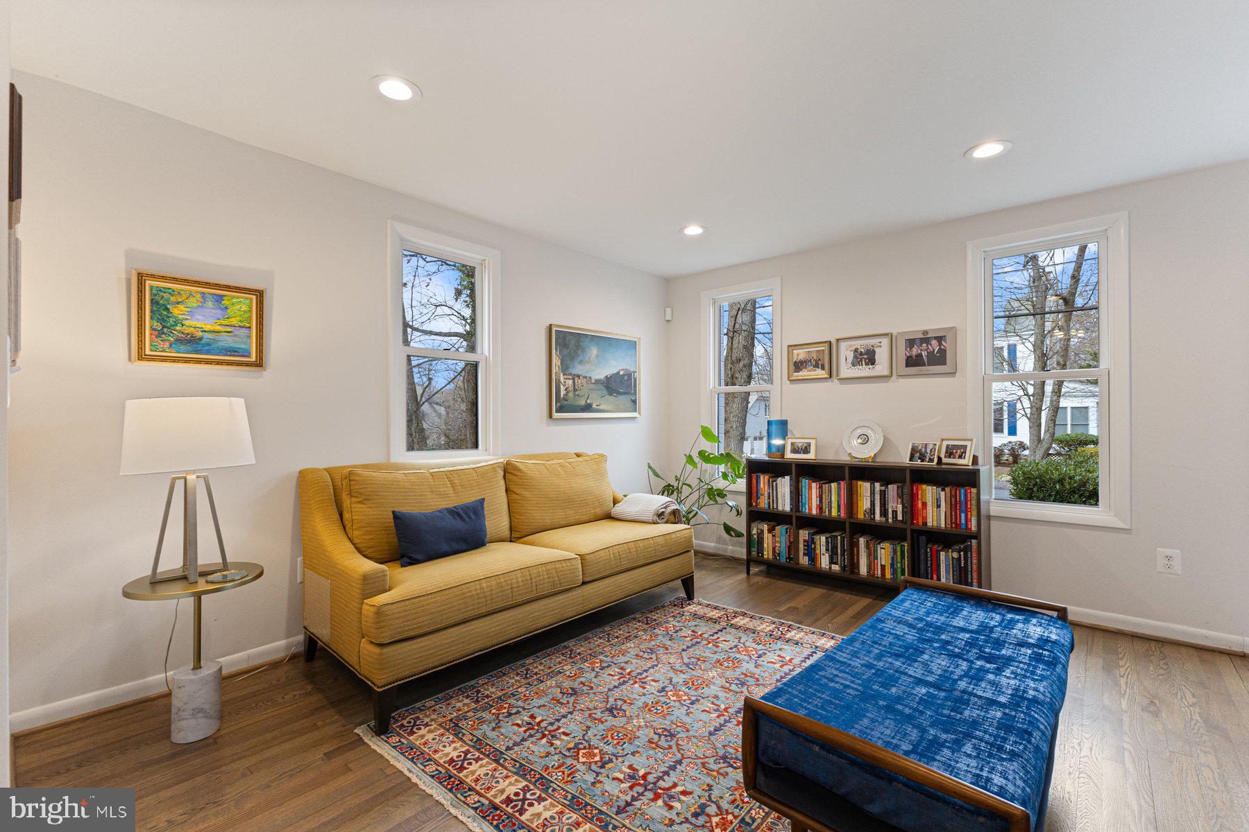 1875 Massachusetts Avenue McLean, VA 22101 - Photo 25 of 52 a living room with a couch and paintings on the wall
