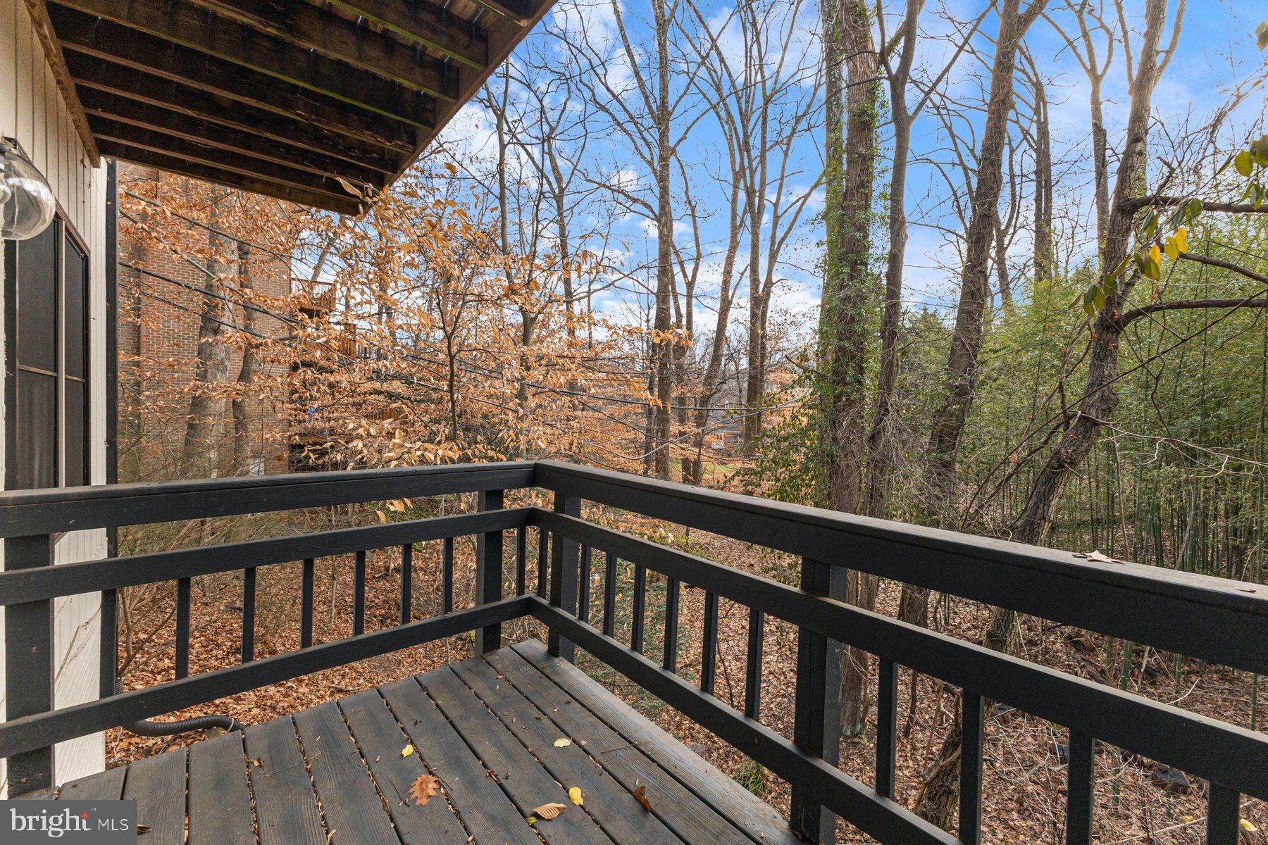 1875 Massachusetts Avenue McLean, VA 22101 - Photo 32 of 52 a view of balcony with wooden floor and fence