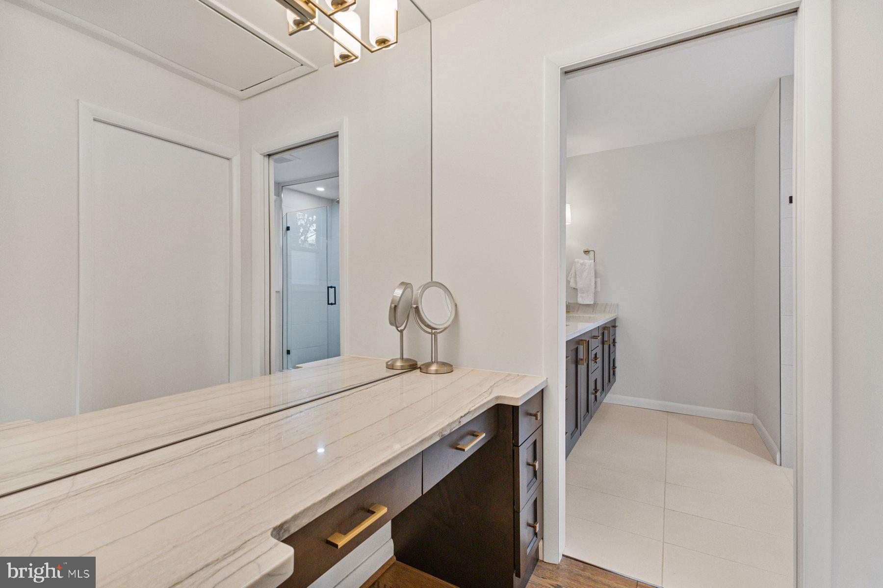1875 Massachusetts Avenue McLean, VA 22101 - Photo 49 of 52 a en suite bathroom with a granite countertop sink and a mirror