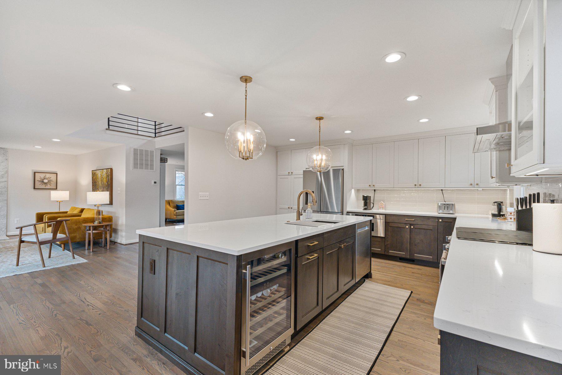 1875 Massachusetts Avenue McLean, VA 22101 - Photo 10 of 52 a large kitchen with kitchen island a sink table and chairs