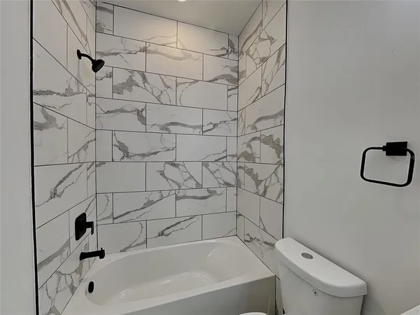 a bathroom with a bathtub and shower