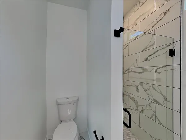 a bathroom with a toilet and shower