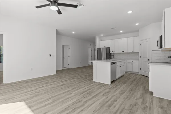 a view of kitchen with cabinets and wooden floor