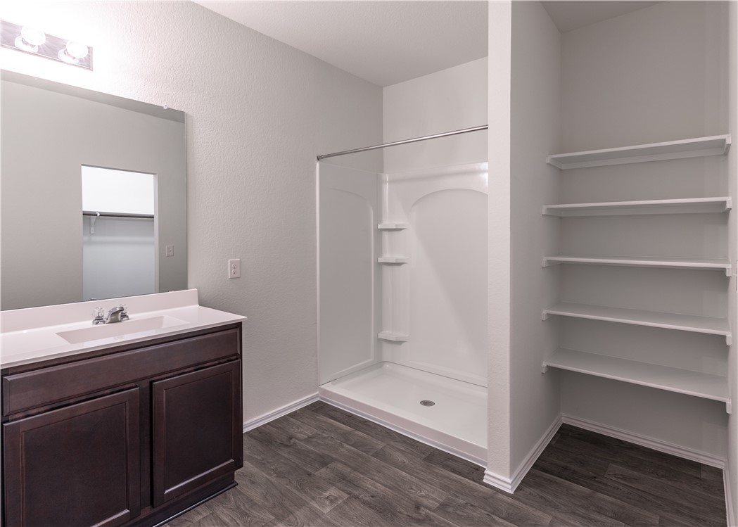 15204 Kent Justin Austin, TX 78725 - Photo 16 of 22 a bathroom with a shower sink and mirror