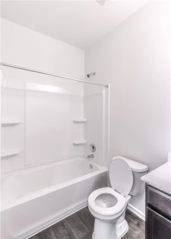 a bathroom with a toilet and a bathtub