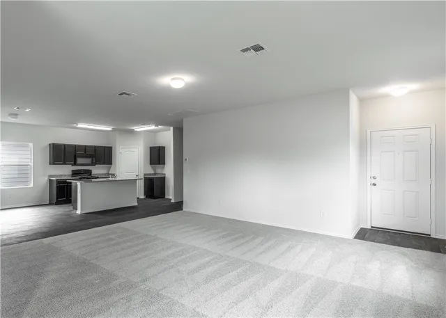 a view of kitchen with refrigerator and chairs
