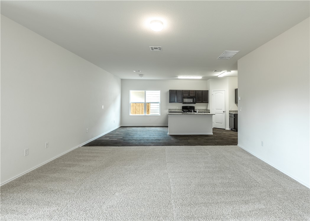 15204 Kent Justin Austin, TX 78725 - Photo 3 of 22 a view of a kitchen with a sink microwave and cabinets