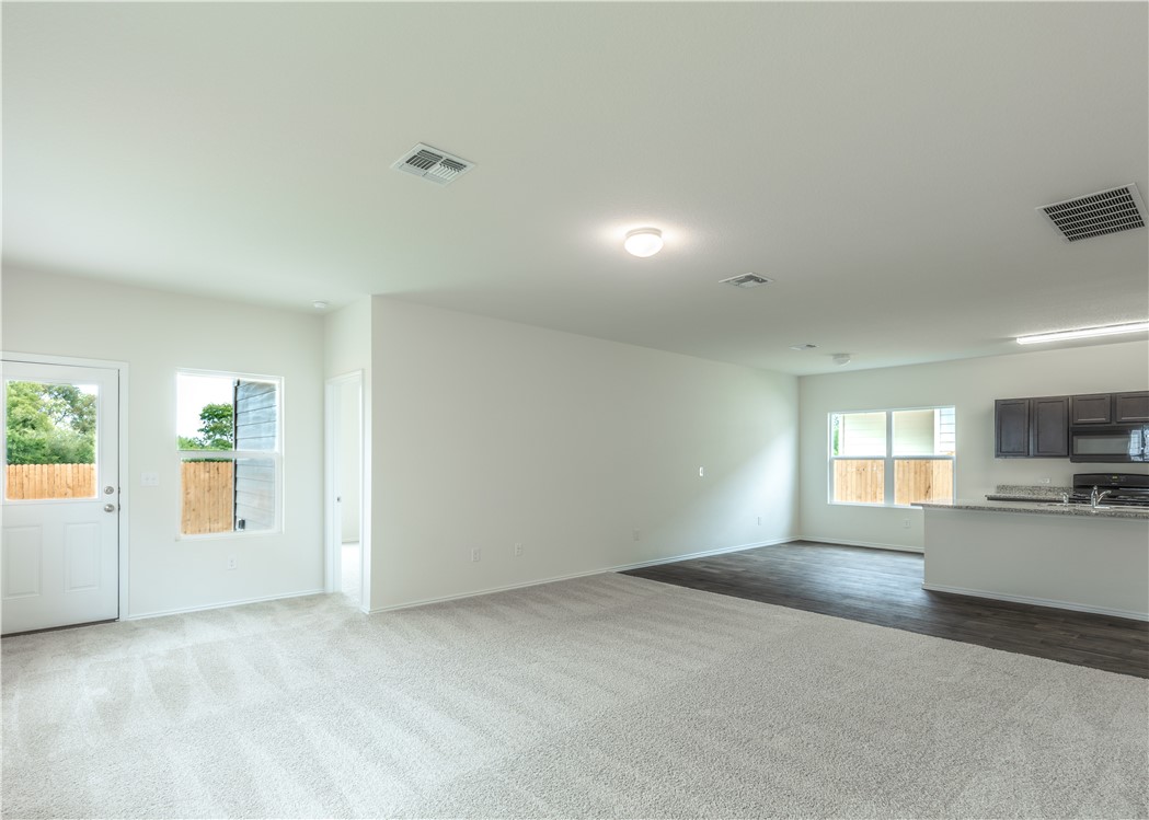 15204 Kent Justin Austin, TX 78725 - Photo 4 of 22 a view of a kitchen and a windows in an empty room