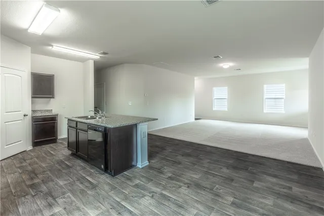 a spacious bathroom with a double vanity sink a mirror and a bathtub