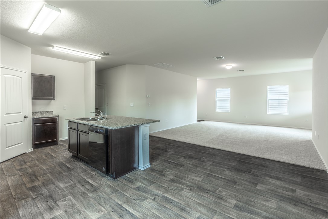 15204 Kent Justin Austin, TX 78725 - Photo 7 of 22 a spacious bathroom with a double vanity sink a mirror and a bathtub