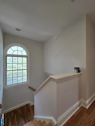 a view of room with window and wooden floor