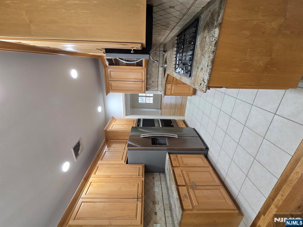 139 Stonegate Trail, Unit 40 Cresskill, NJ 07626 - Photo 7 of 23 a kitchen with stainless steel appliances granite countertop a stove a sink and a refrigerator