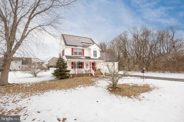 a view of a house with snow on the road