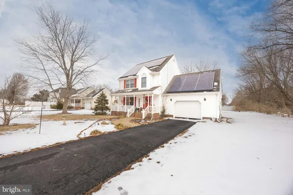 a view of a house with snow on the road