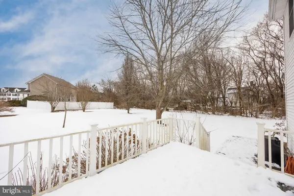 a view of a house with a yard covered in snow
