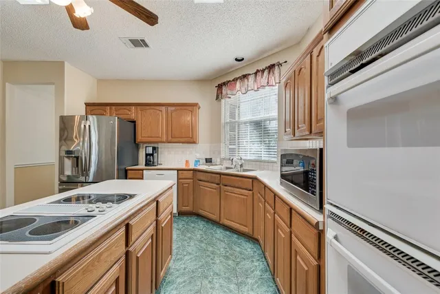 a kitchen with a sink stove and refrigerator