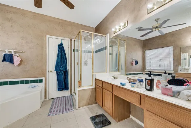 a bathroom with a tub a sink and a mirror