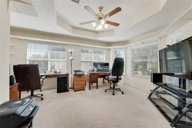 a view of a workspace with furniture and a window