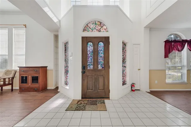 an entryway with a fireplace and windows