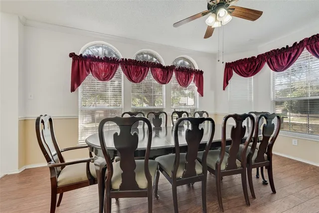 a view of a dining room that has a table and chairs in it