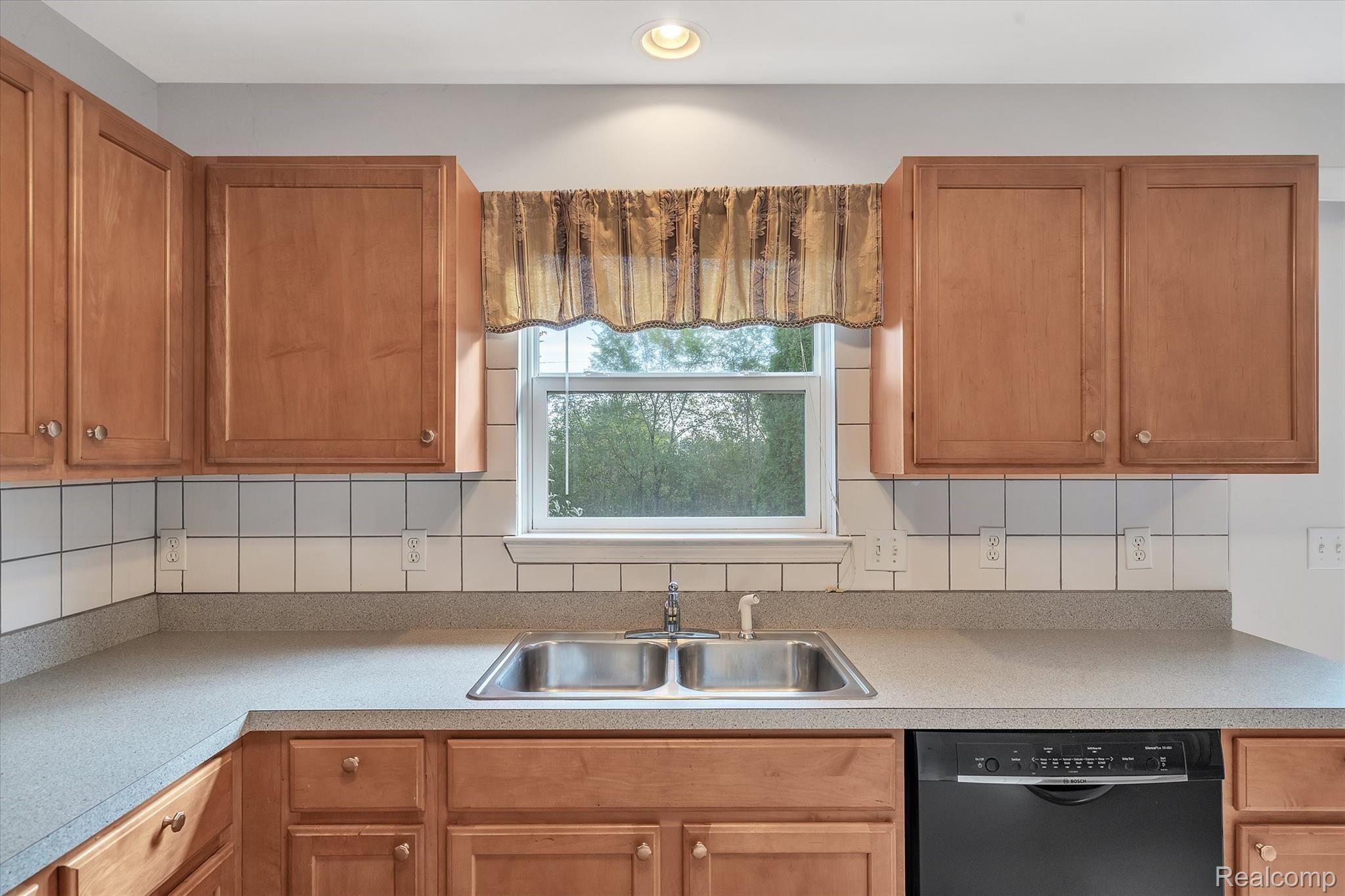 2874 Laurel Ridge Lane Howell, MI 48843 - Photo 13 of 34 Kitchen window overlooks backyard.