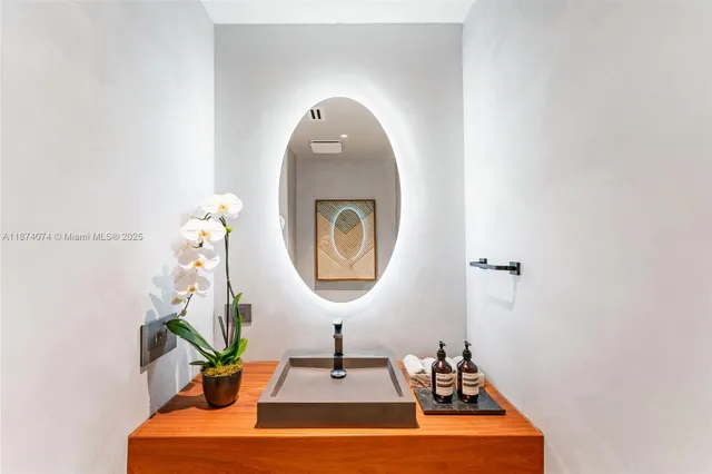 a room with a sink and a mirror