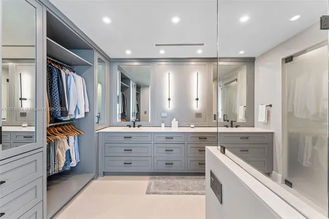 a bathroom with a tub sink shower and mirror