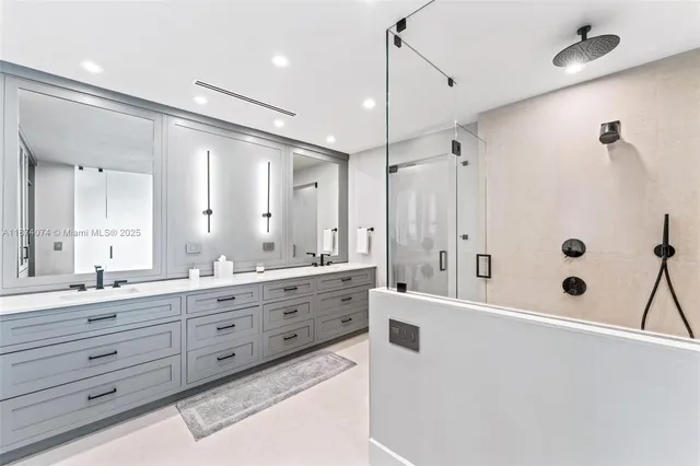a spacious bathroom with a granite countertop sink mirror and a bathtub