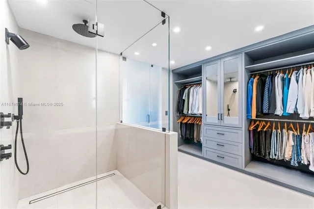 a bedroom with a large bed couch and a window