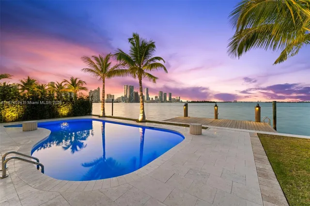 a swimming pool with outdoor seating and yard