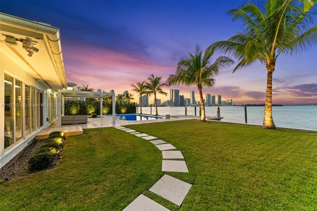 a swimming pool with outdoor seating and yard