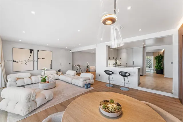 a living room with furniture potted plant and a chandelier