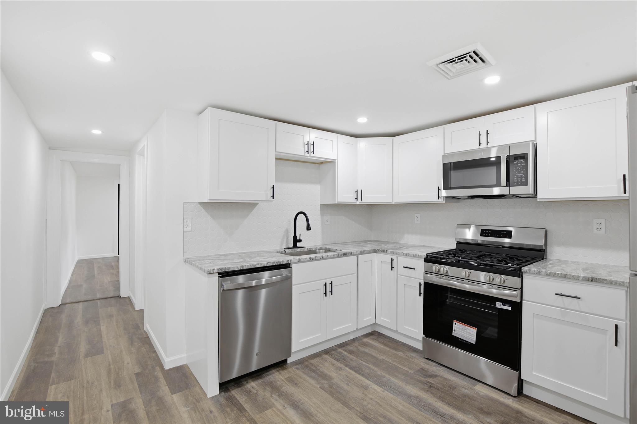 751 High Street Lancaster, PA 17603 - Photo 15 of 41 a kitchen with stainless steel appliances granite countertop a stove a sink and a microwave