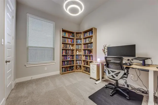 a view of a livingroom with workspace and a window