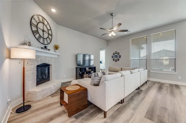 a living room with furniture a fireplace and a chandelier
