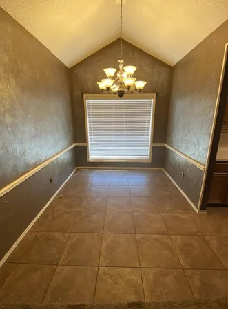 a view of kitchen with granite countertop and sink