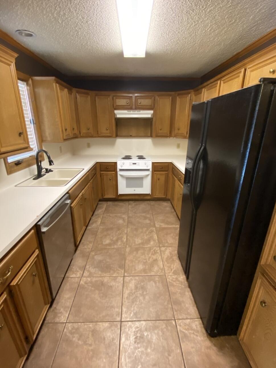 6818 Huron Avenue Lubbock, TX 79424 - Photo 4 of 11 a large kitchen with a large counter top space appliances and cabinets