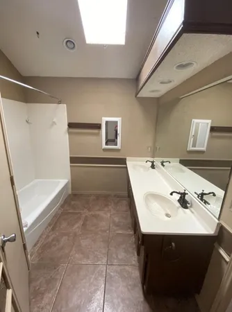 a bathroom with a sink and mirror